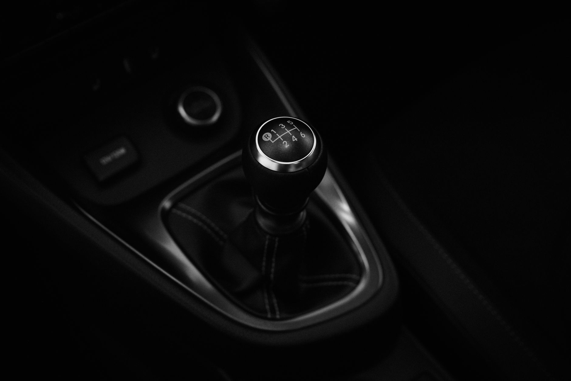 A red hot hatch with manual gearbox on a UK country road, representing manual gearbox cars UK buying in 2026