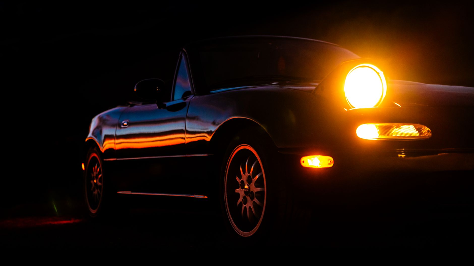 Clean Mk1 Mazda MX-5 on a British country road, a rising Mazda MX-5 classic investment UK buyers are watching closely