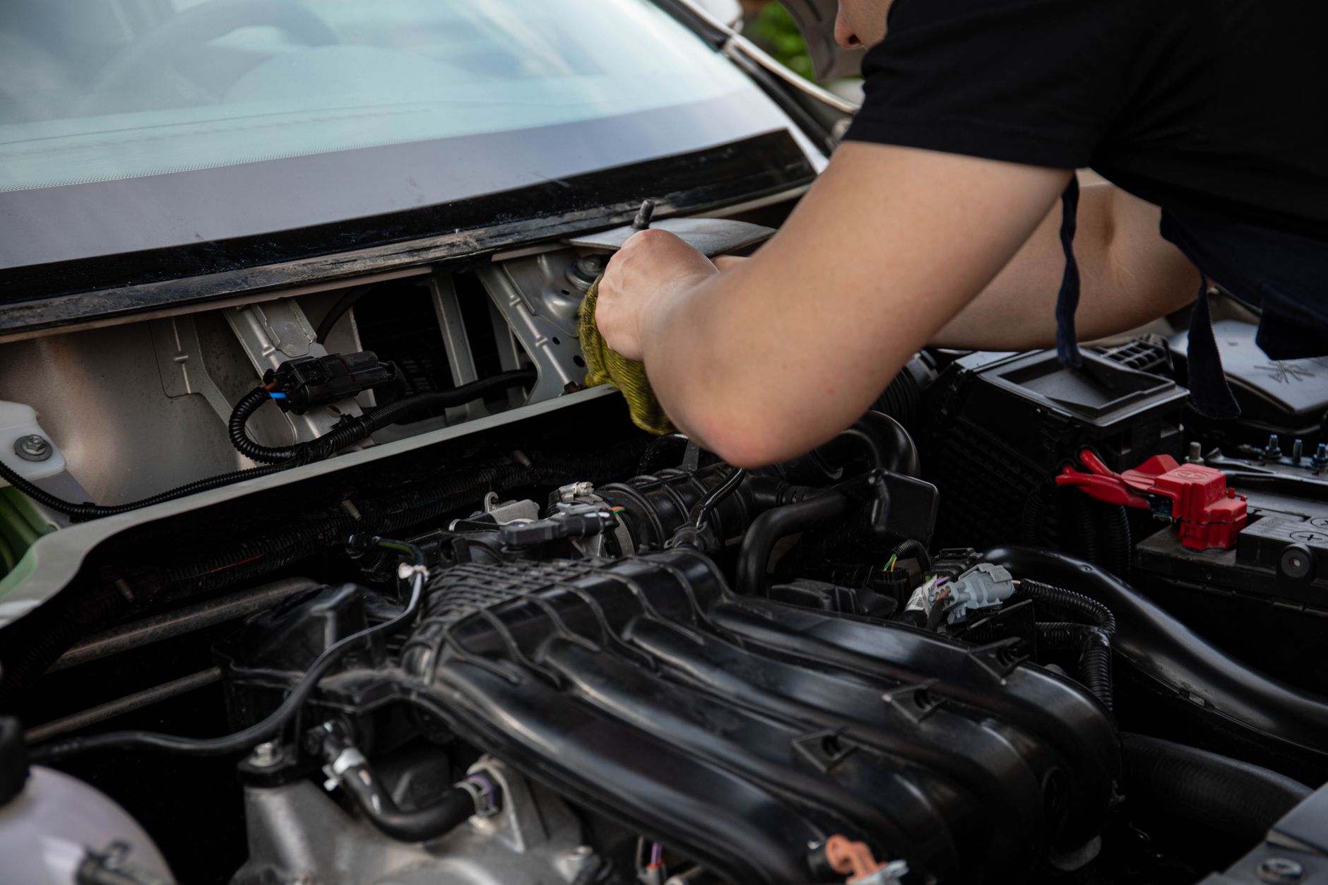 Mechanic inspecting a modified engine bay, a common issue for garage refusing to service modified car UK owners